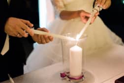 couple light Unity candle during wedding ceremony